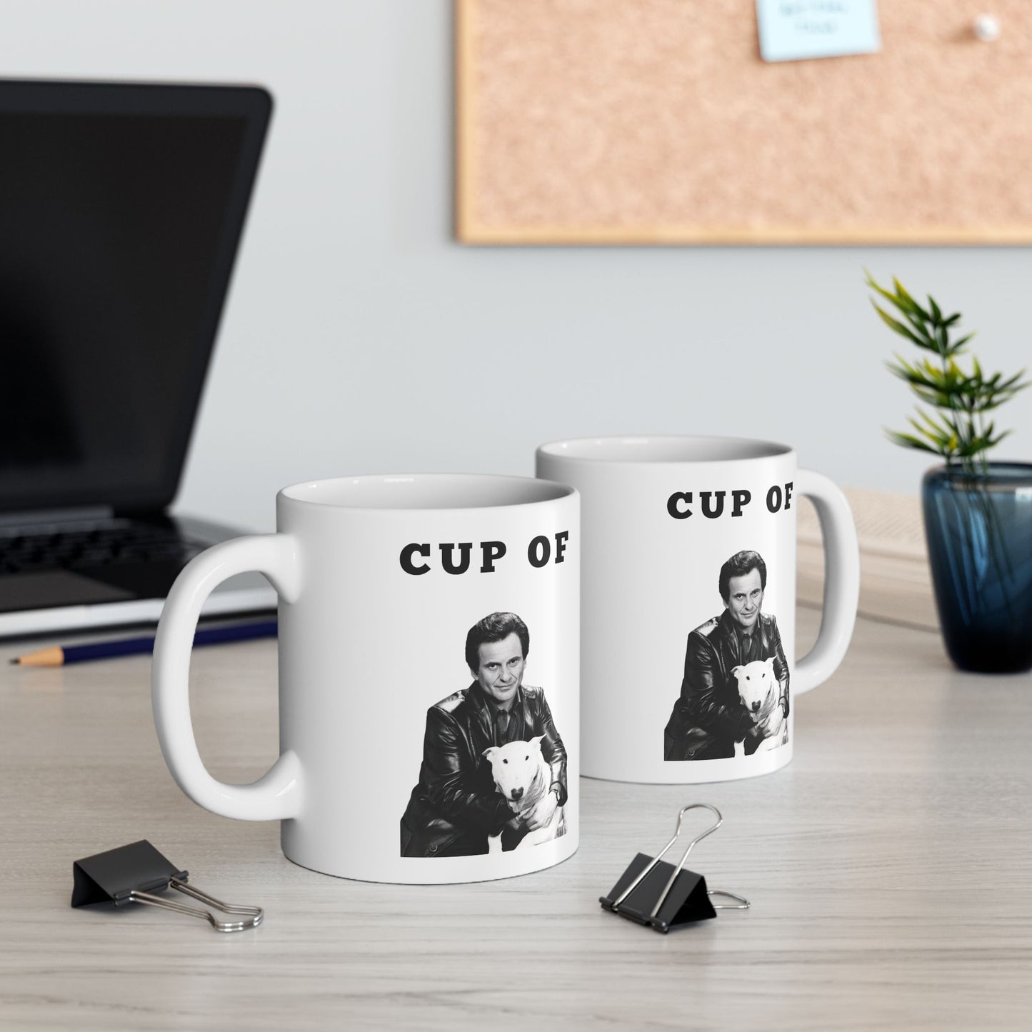 Two white ceramic Cup of Joe mugs featuring Joe Pesci and a dog, displayed on a desk with office supplies in the background.